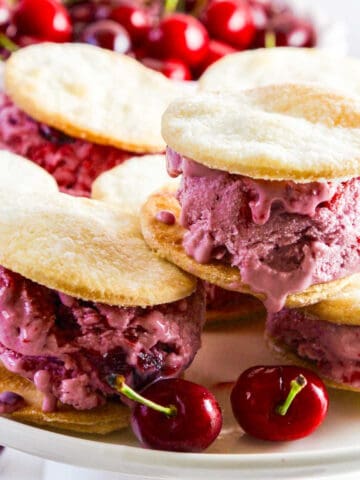 A white platter with cherry pie ice cream sandwiches.
