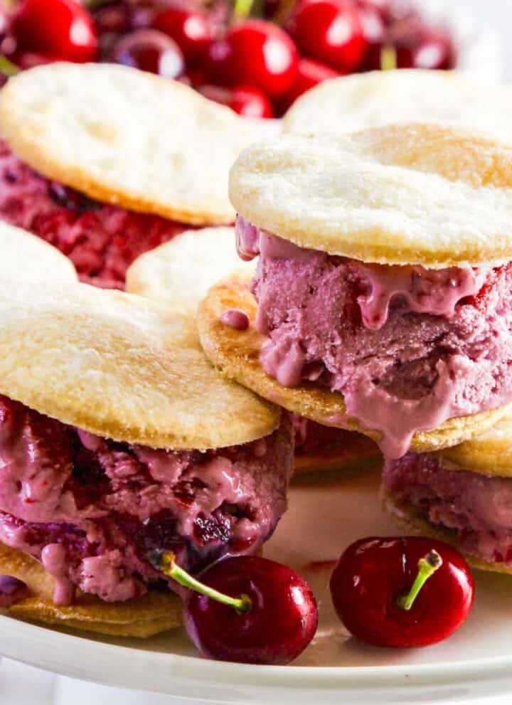 A white platter with cherry pie ice cream sandwiches.