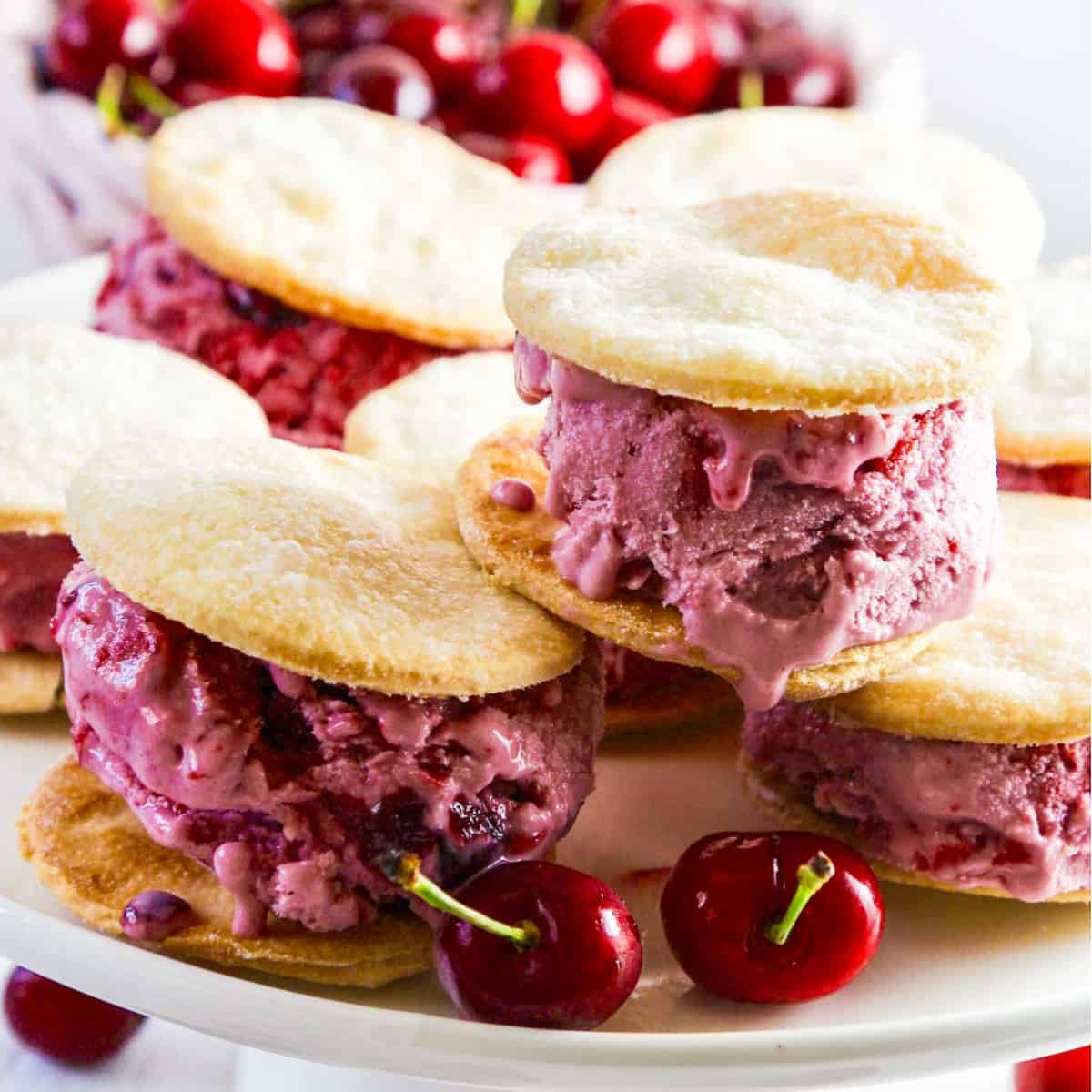 A white platter with cherry pie ice cream sandwiches.