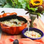 A blue bowl filled with homemade chicken noodle soup.