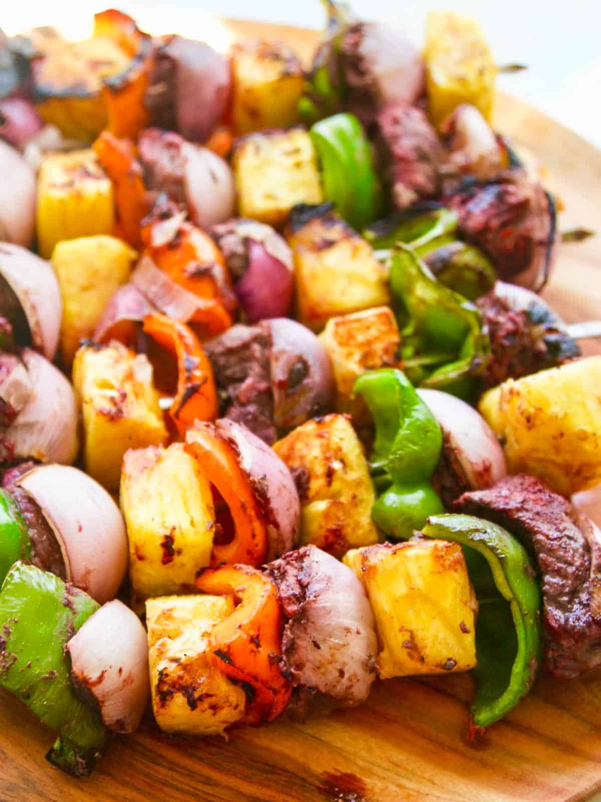 Grilled skewer shish kabobs made with beef, bell pepper, pineapple, and onion.