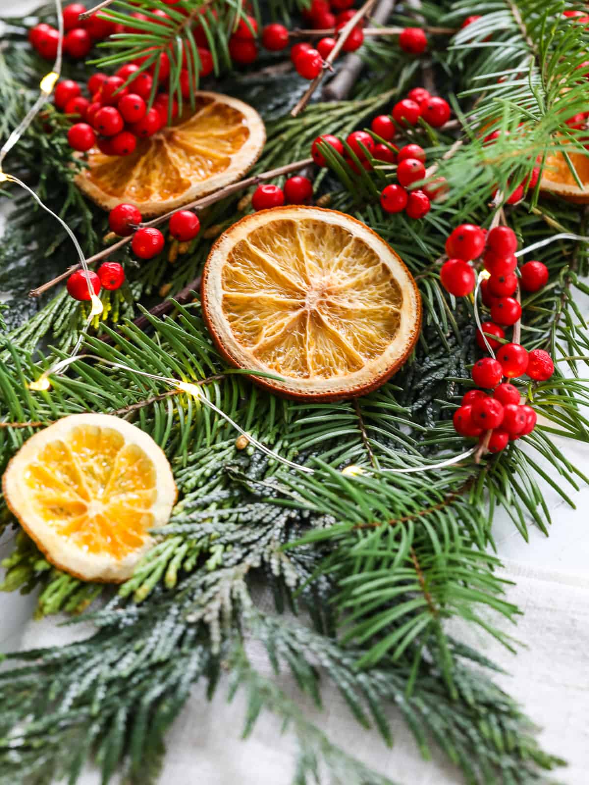 Hanging Christmas decoration of dried oranges, tangerine and cinnamon  stars. holiday concept. blurred background Stock Photo - Alamy
