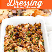 A large white casserole dish filled with golden baked dressing for Thanksgiving.