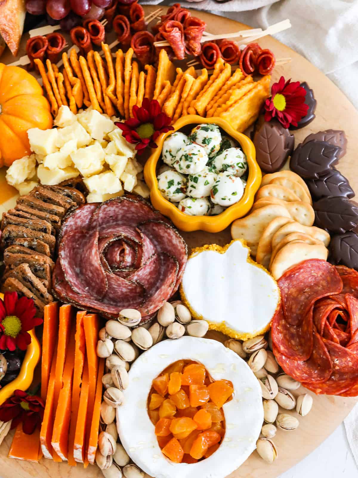 A Thanksgiving charcuterie board loaded with sliced meats and cheeses for a party.