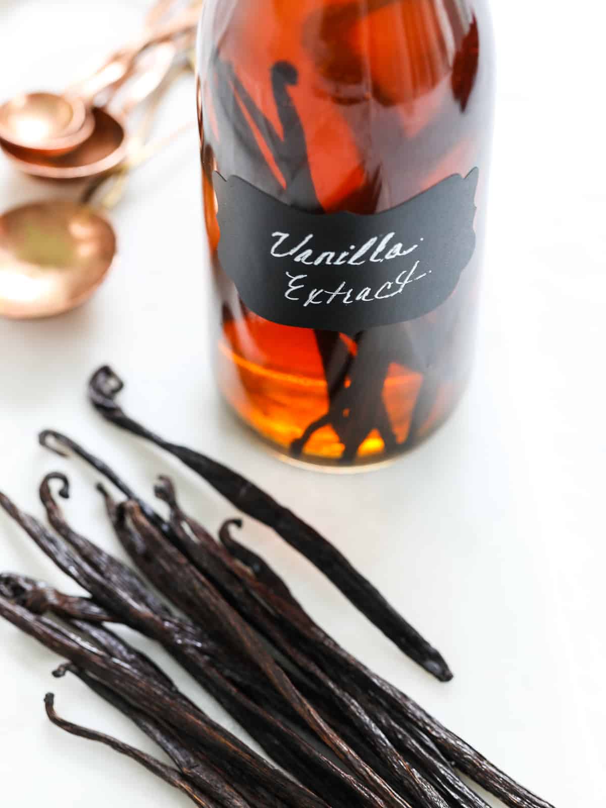 Close up of a bottle of homemade vanilla extract with the pods in the bottle.