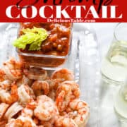 A glass platter filled with cooked shrimp for shrimp cocktail with the seafood dipping sauce.