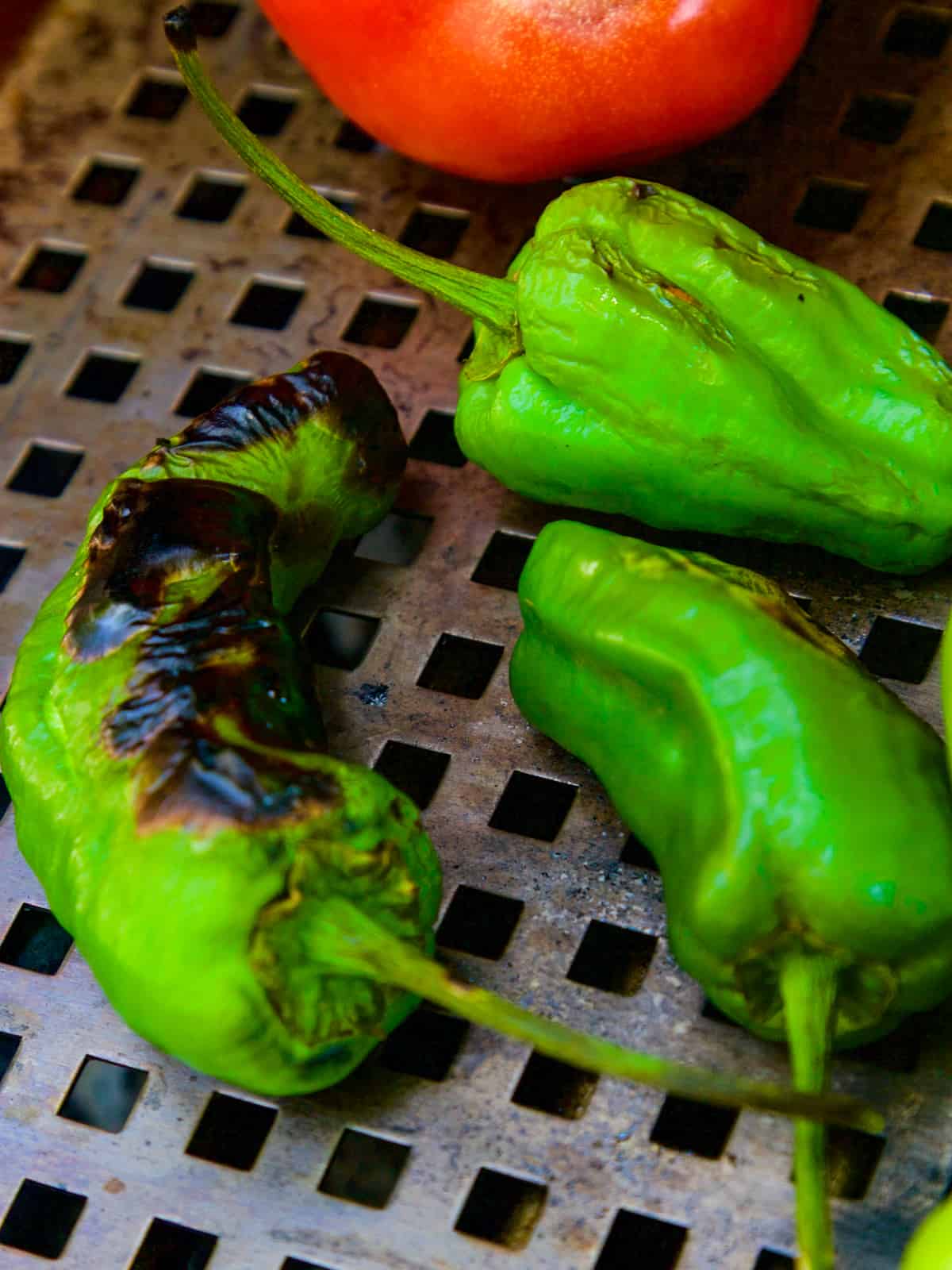 Grilling three chiles for making homemade tomatillo salsa.
