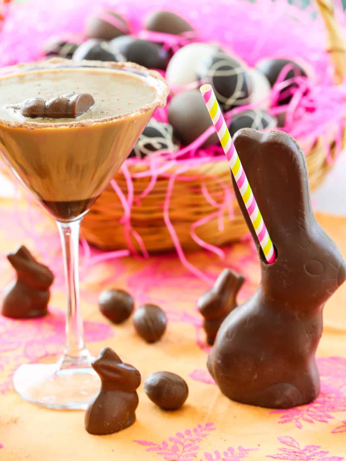 Chocolate martini in a garnished glass for Easter sunday and a basket filled with eggs.