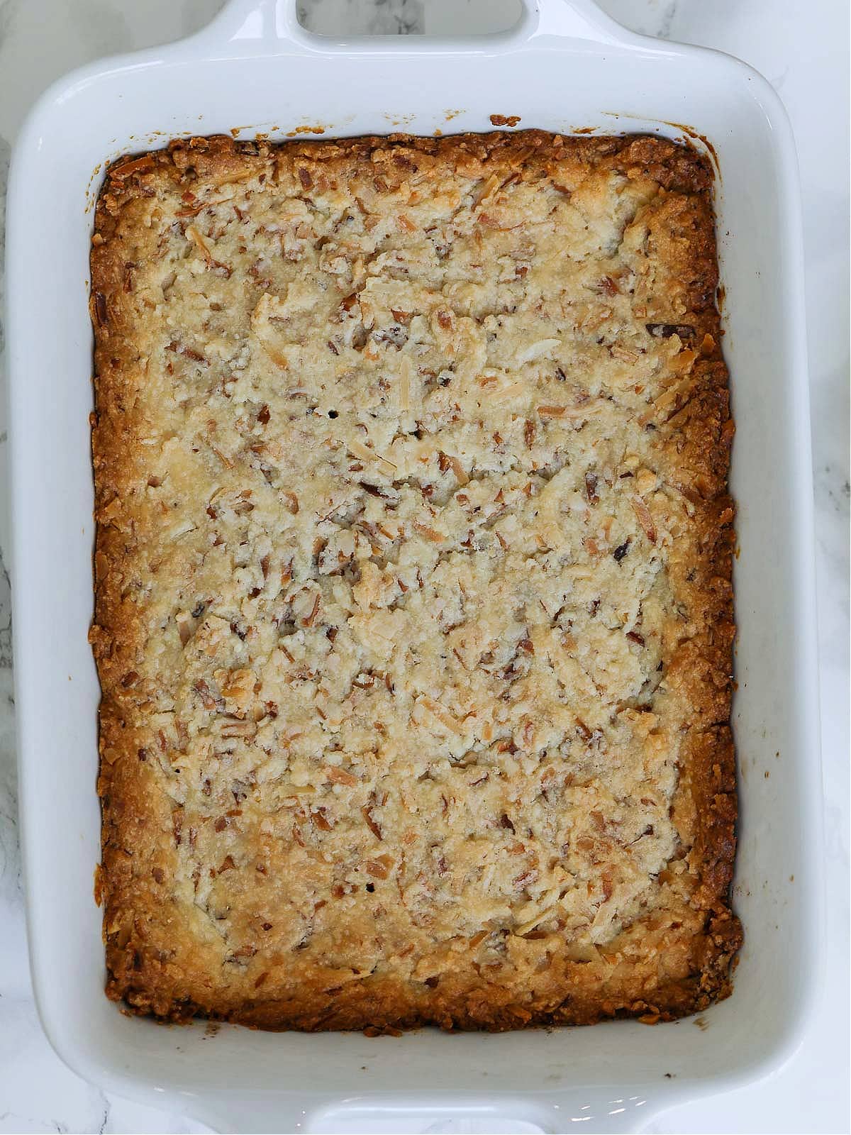 A baked cookie crust made from coconut for tropical lemon bars. 