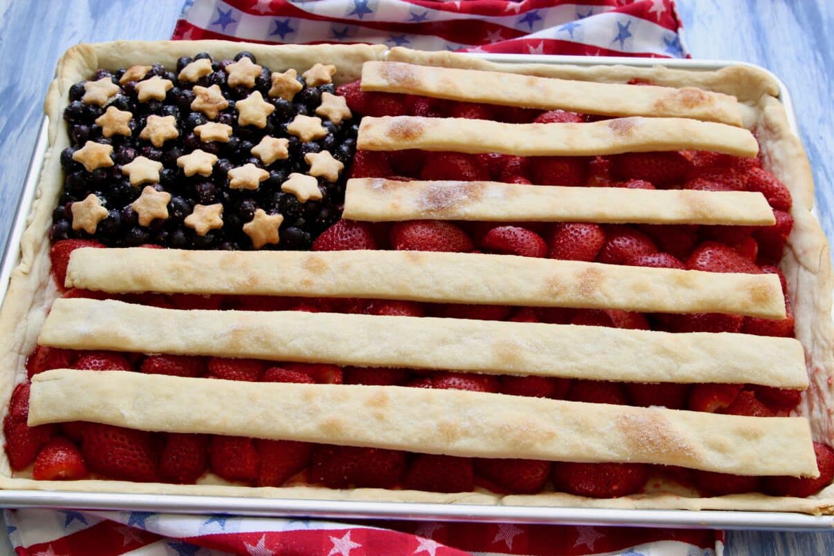Close up of American flag pie baked in sheet pan with strawberry filling.