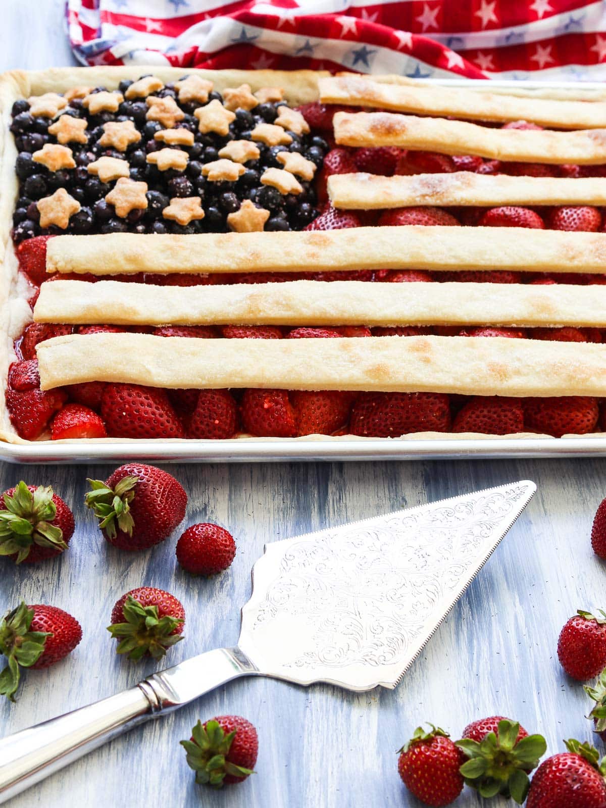 A flag slab pie baked with a silver pie server utensil.
