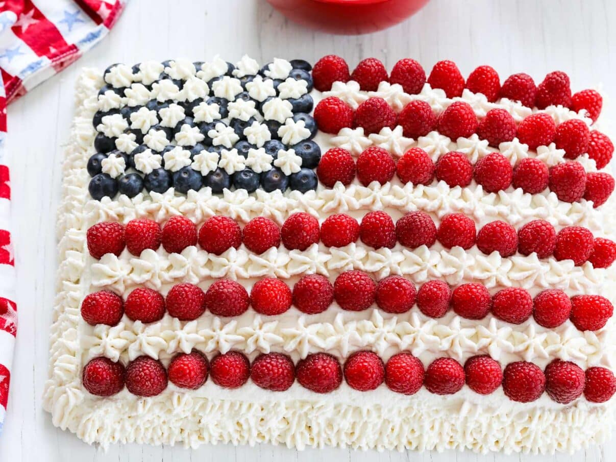 Close up of a red white and blue flag cake made with fruit.