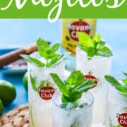 Mojito cocktails on a woven mat garnished with mint and a Cuban cigar.
