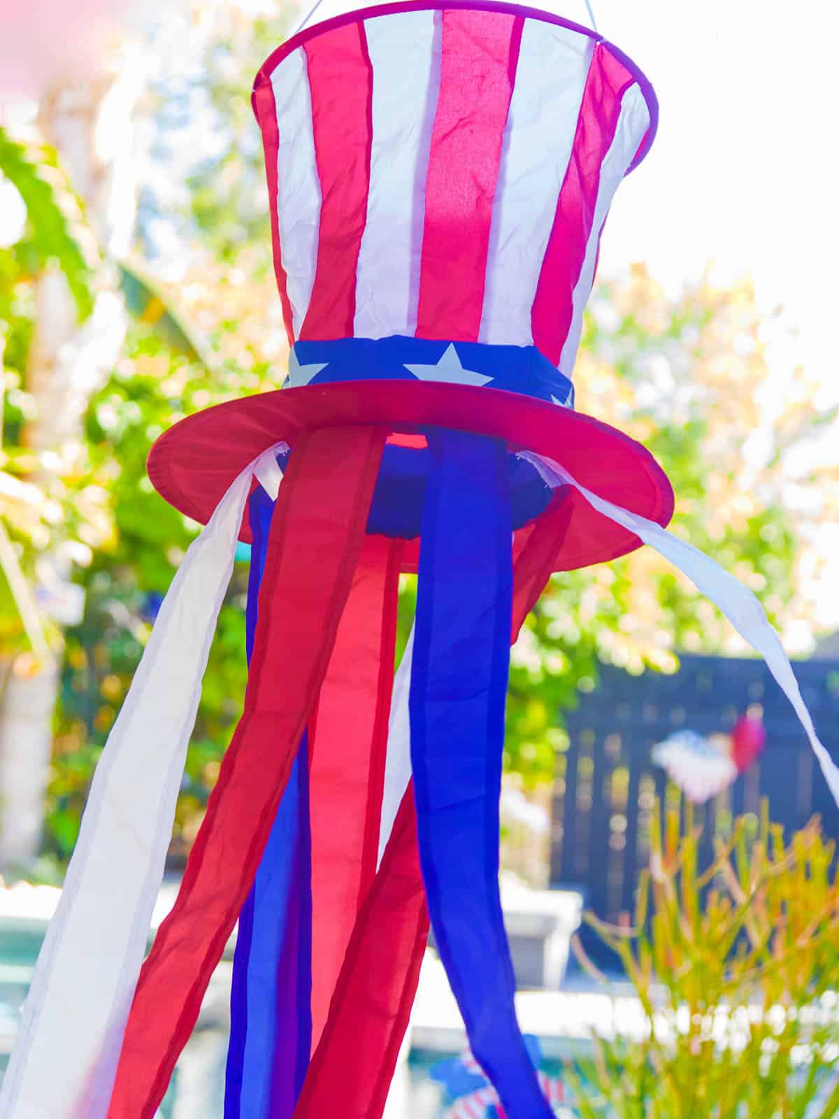 A red white and blue old Sam hat blowing in the wind on 4th of July. 