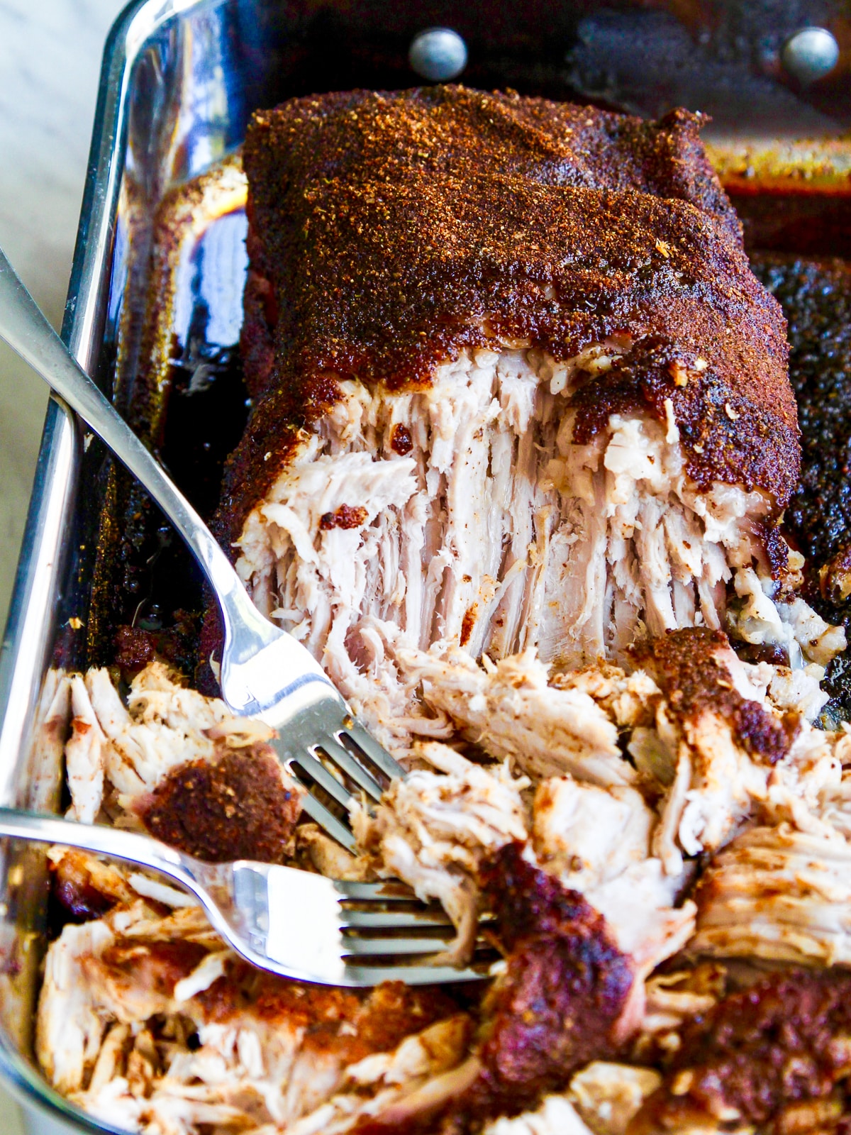 https://www.delicioustable.com/wp-content/uploads/2023/07/Pulled-Pork-Oven-Roasted-Low-Slow-shredding-and-pulling-pork-with-two-forks.jpg