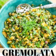 A turquoise blue bowl filled with a gremolata mixture to top meat, fish and chicken and more.