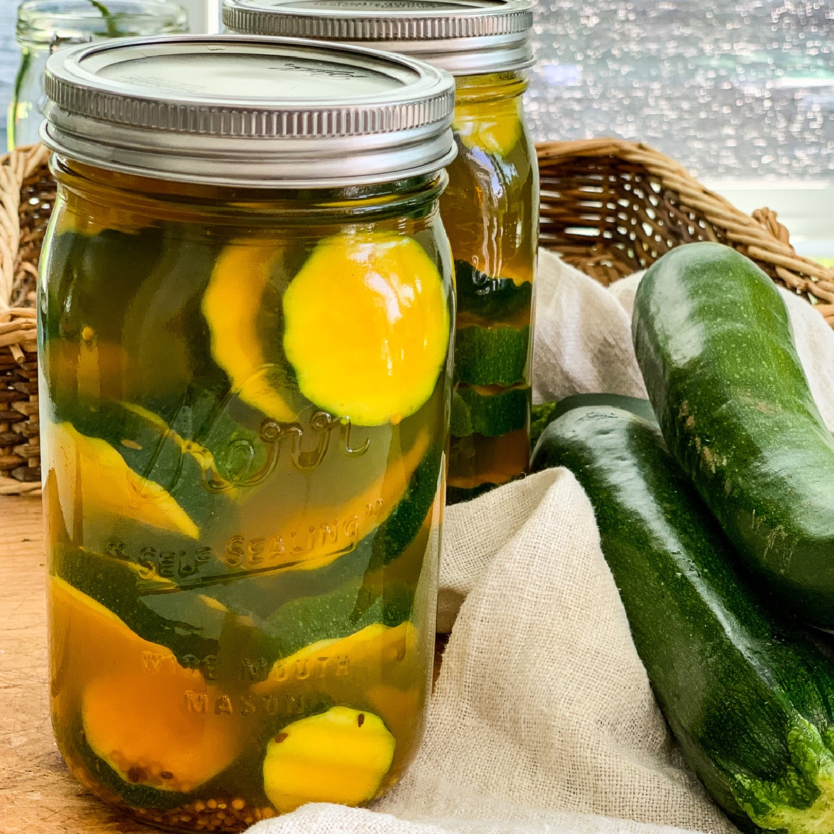 Close up of zucchini pickles in a quart glass mason jar.