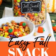 A tall clamp jar filled with a recipe for Fall Snack Mix with peanuts, candy corn and M&M candy.